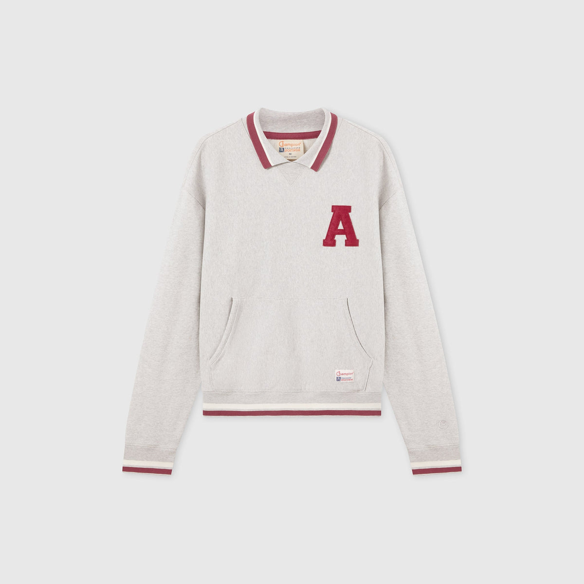 Men’s Knitted Polo Neck Sweatshirt by Champion, featuring a light gray color with long sleeves, a polo collar accented with maroon trim matching the cuffs, a maroon letter A patch on the left chest, and a small label near the hem. Crafted from soft Modern Ametora Reverse Weave fleece and presented laid flat on a white background.