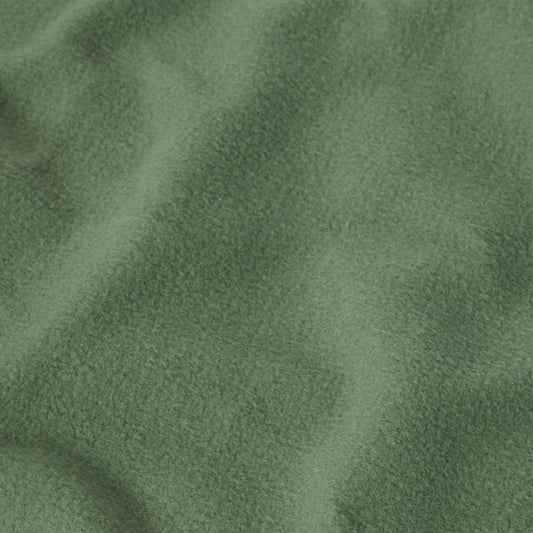 A close-up of heavyweight fleece fabric from the Champion Men’s Relaxed Fit Crewneck Sweatshirt, displaying a soft, textured surface with gentle folds and shadows.