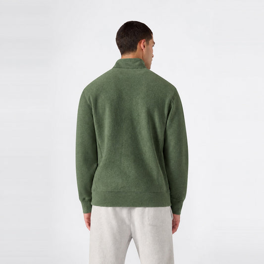 Back view of a person wearing a green Champion Men’s Knitted Half Zip Sweatshirt and grey sweatpants.
