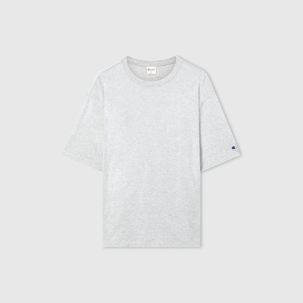 The Men’s Knitted T-Shape Tee by Champion is displayed flat on a gray background. This sportswear staple features a classic crew neckline, a subtle Champion logo on the left sleeve, and is crafted from heavyweight cotton to ensure lasting comfort and durability.
