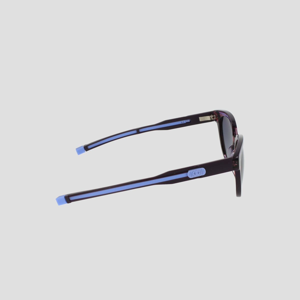 Side view of Champion Women's Polarized Retainer Round sunglasses featuring dark frames with light blue accents on the temple tips and arms, perfect for elevating women’s fashion eyewear against a plain light background.