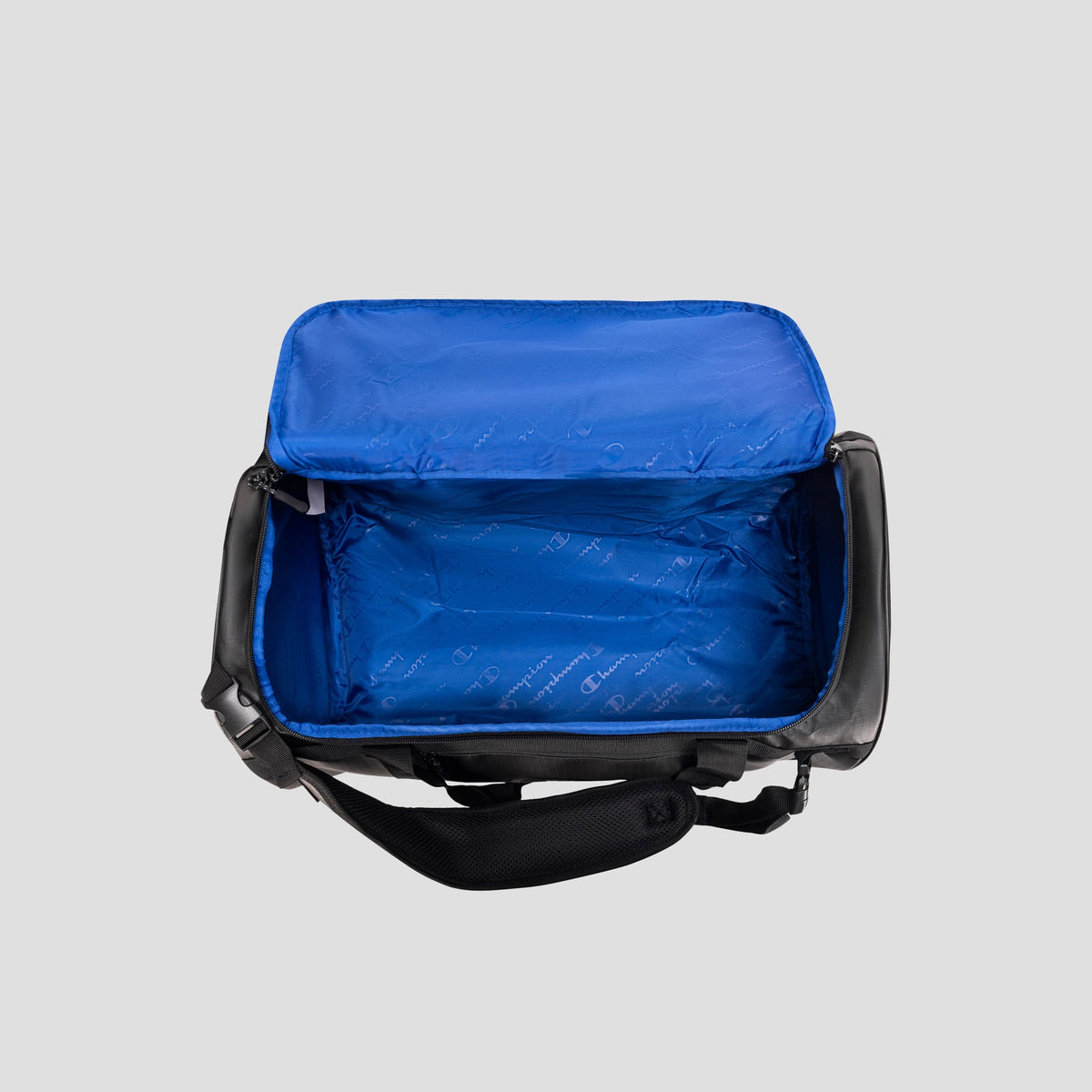 Open black and blue Champion Approach Convertible Duffel insulated lunch bag with blue interior lining, unzipped and empty, shown from above on a plain gray background—its versatile design evokes the look of a compact gym bag or convertible duffel.