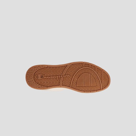 The image shows the sole of the Men's Arena Lo V2 T by Champion, featuring brown color and Champion branding. The tread has herringbone, circular, and textured patterns for traction. The background is plain light gray.