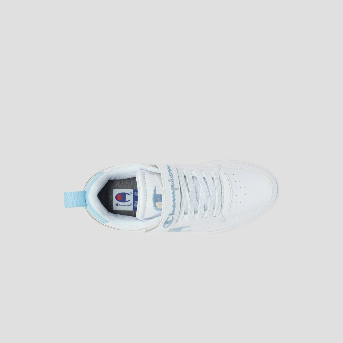 Top view of a white low-top Kids' Arena Power Low sneaker by Champion, featuring light blue accents, a blue pull tab at the heel, perforated toe box, and Champion branding on the tongue and side against a light gray background.