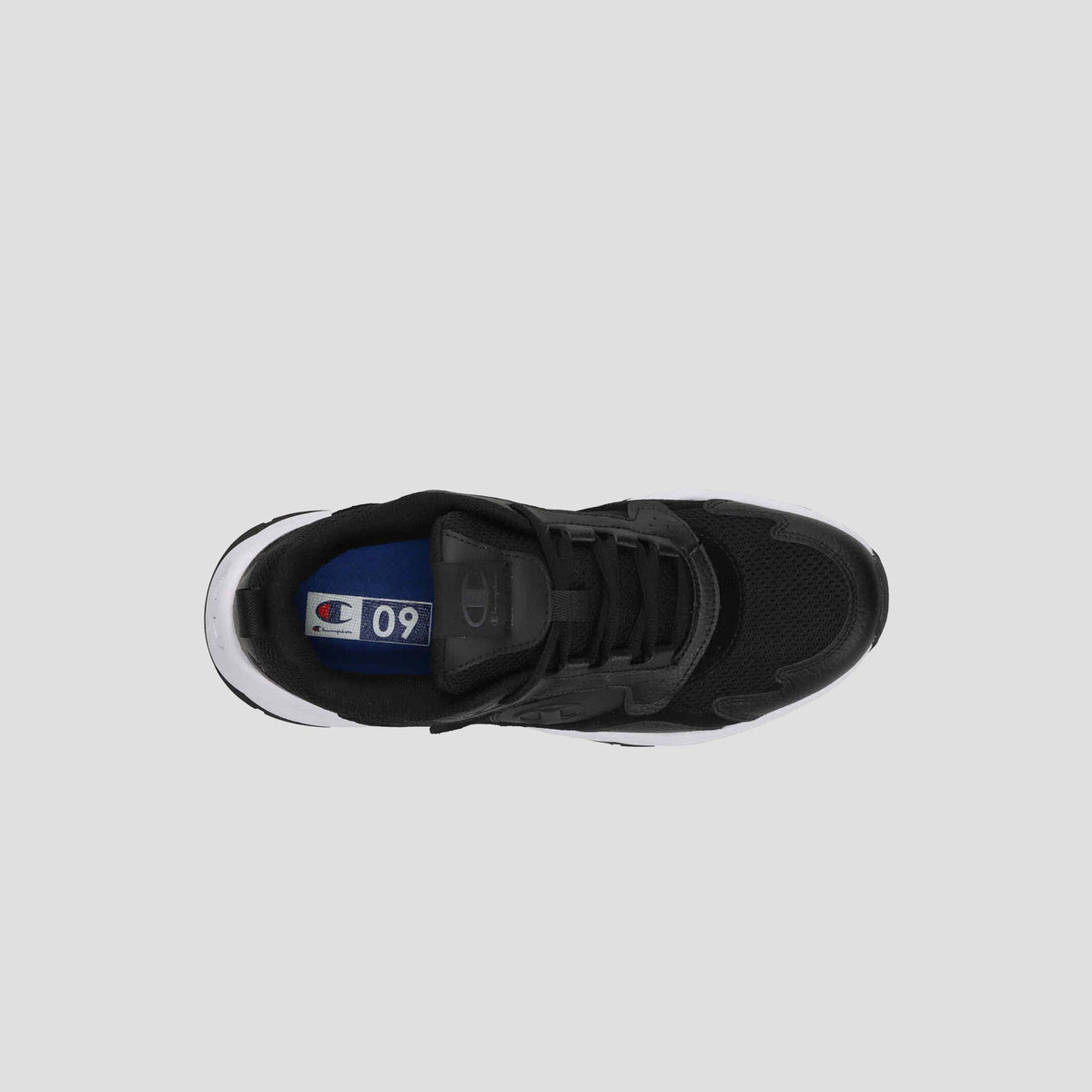 Top view of the Champion Men's 9318 Vale sneaker in black, featuring a leather and mesh upper, white sole, thick black laces, and a blue insole label with the C Champion logo and number 90. Background is light gray.
