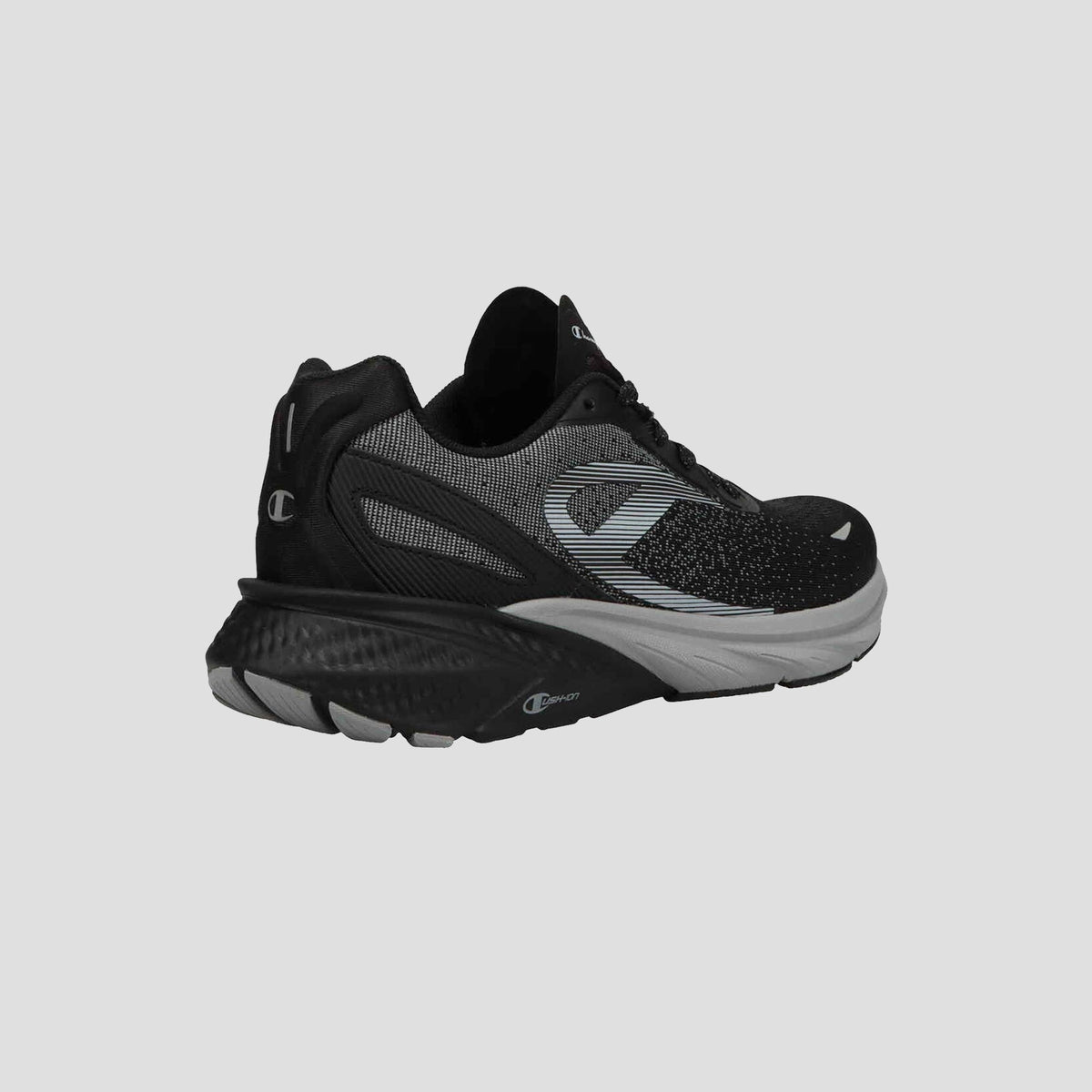 Champion Men's Alpha sneakers in black and gray feature a mesh upper, textured sole, and Champion logos on the side and heel—perfect for gym workouts. Shown on a plain light gray background.