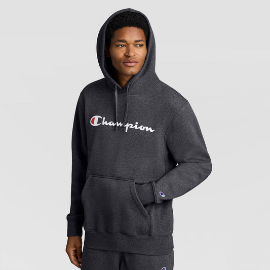 A man wearing a dark gray Champion Powerblend Hoodie, Full Script Logo with the brand name printed in white and red across the chest.