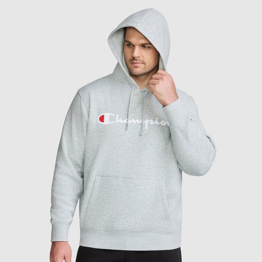 A man wears a heather gray Champion Powerblend Hoodie, Full Script Logo - Big & Tall, featuring a centered chest logo.