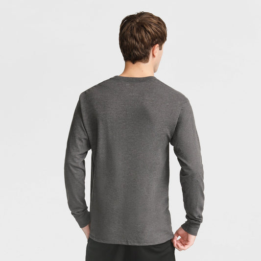 Seen from behind against a white background, a person with short brown hair wears the Champion Classic Long Sleeve T-Shirt, Embroidered C Logo, in dark gray and black pants.