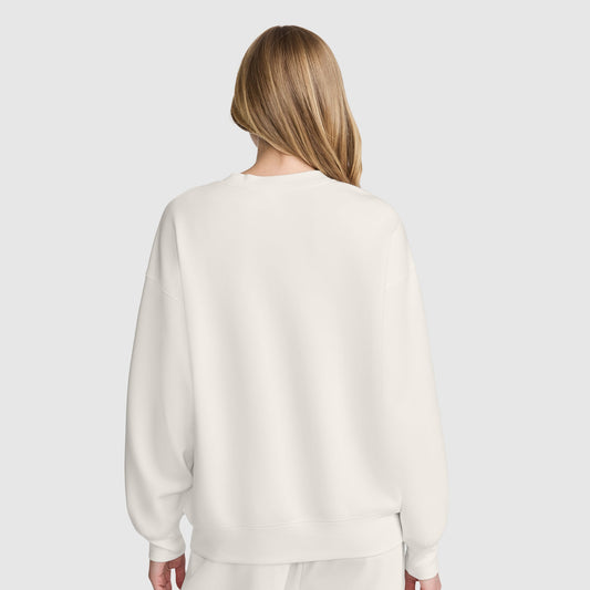 Back view of a person wearing a plain white Champion Crewneck Pullover Sweatshirt with an athletic silhouette.