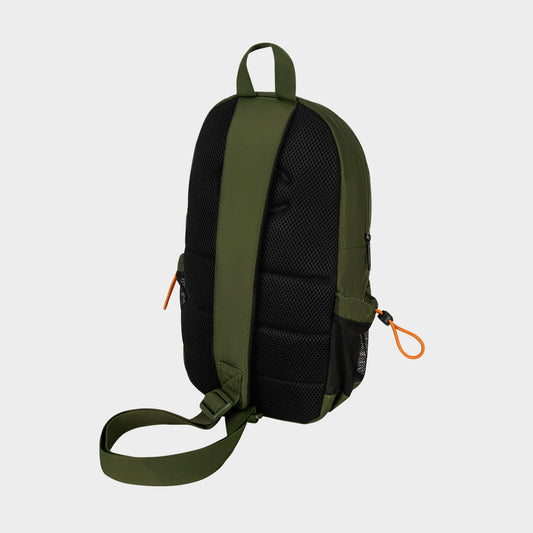A Champion Camden Sling backpack in green and black is displayed from the back, highlighting padded straps, a single adjustable strap, and distinctive orange zipper pulls. Made from durable nylon, this sling bag is set against a light gray background.