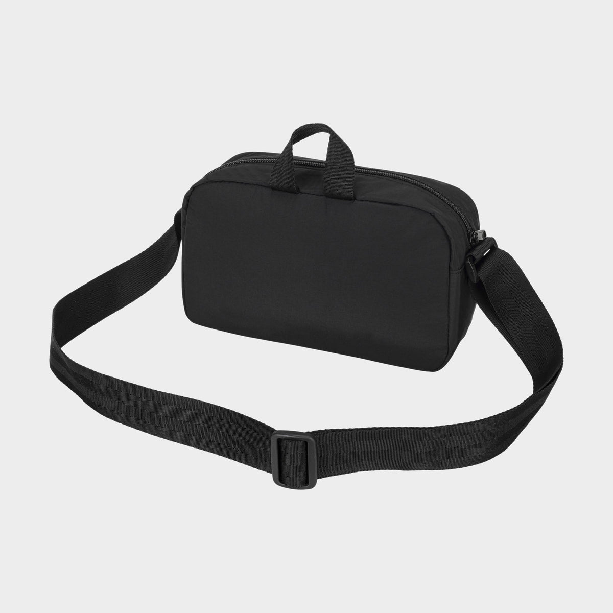 The Champion Explore Crossbody, crafted from durable black nylon, features a wide adjustable strap and two small handles, and is displayed on a plain light background.
