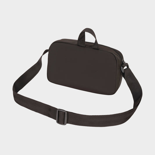 The Champion Explore Crossbody is a black rectangular bag made from durable crinkle nylon, featuring a long adjustable strap for hands-free use and two small top handles, shown against a plain white background.
