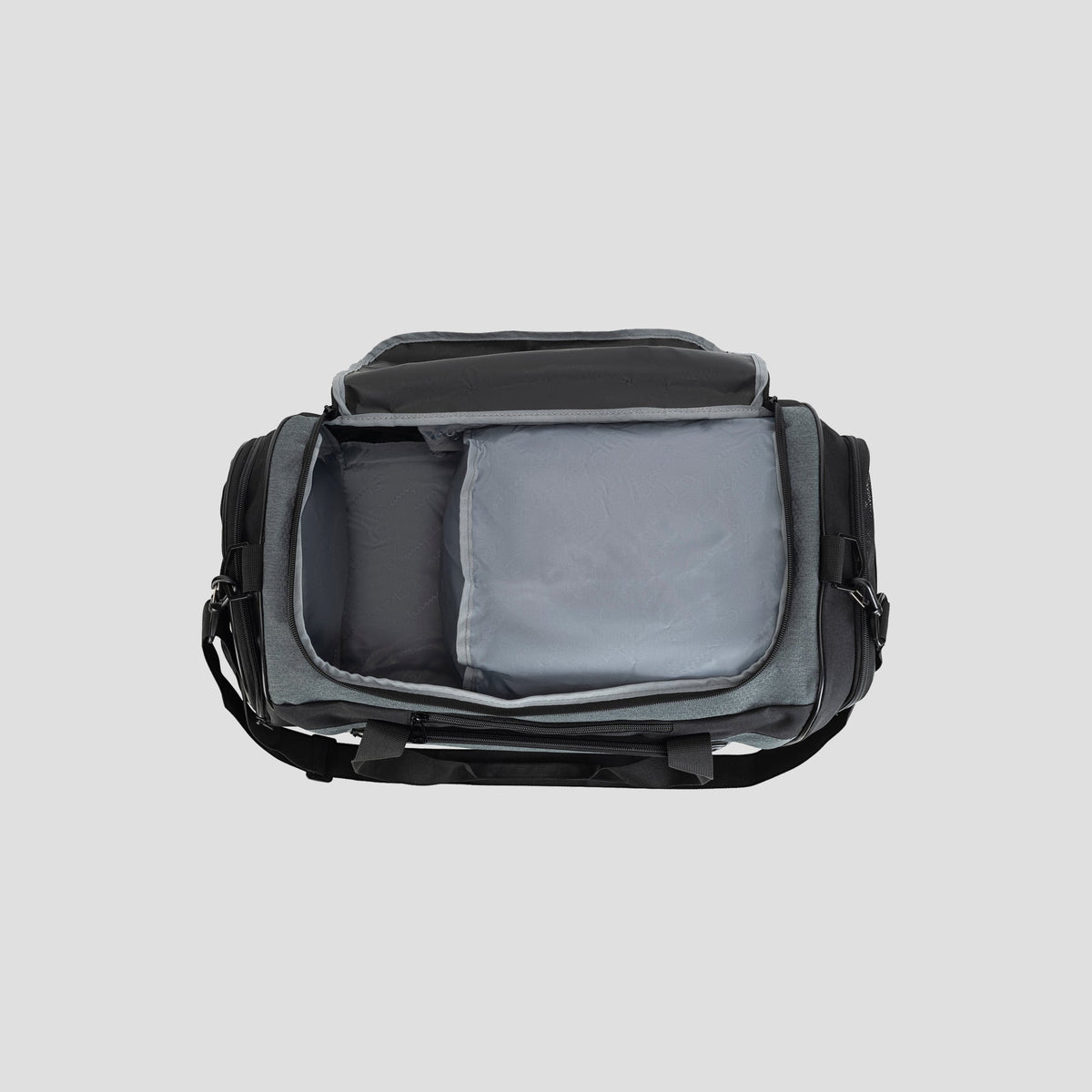 A black and gray Champion Stadium Duffel Bag is displayed from above, unzipped to reveal its spacious and well-organized interior compartments against a simple light gray background.