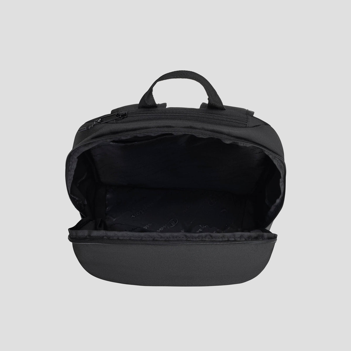 The Champion System Backpack is shown open against a plain gray background, displaying its empty main compartment with a visible zipper and handle, as well as multiple storage compartments for easy organization.