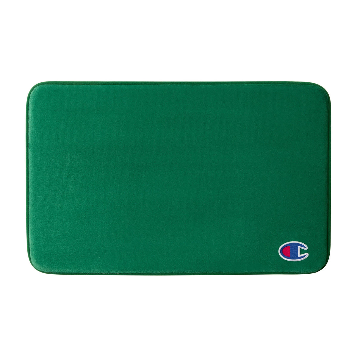 A green rectangular Logo Patch Memory Foam Bath Mat by Champion, featuring rounded corners and a small Champion logo patch on the bottom right, designed with plush memory foam for enhanced comfort and a skid-resistant backing to keep it securely in place.