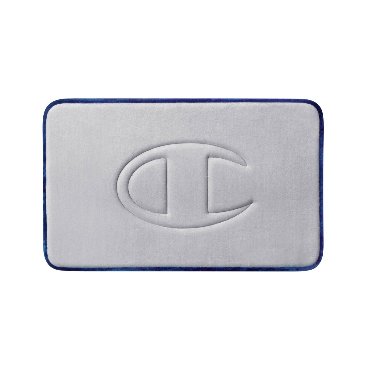A light gray, rectangular Quilted Logo Memory Foam Bath Mat by Champion features rounded corners, dark blue edging, and a large embossed Champion “C” logo at the center. This stylish bath mat provides both comfort and a modern touch to your bathroom space.