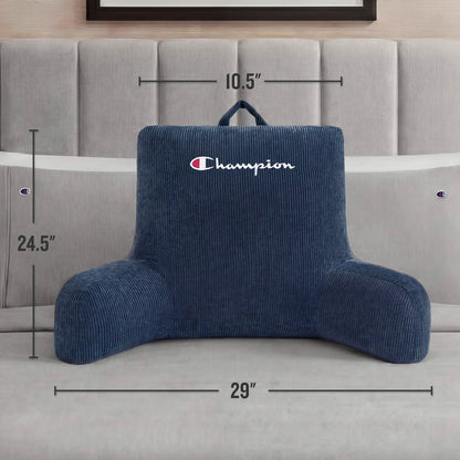 A Champion Corduroy Backrest Pillow with arms, featuring a soft blue corduroy cover and the embroidered Champion logo, sits on a bed. The pillow measures 24.5 inches tall, 29 inches wide, and 10.5 inches deep.