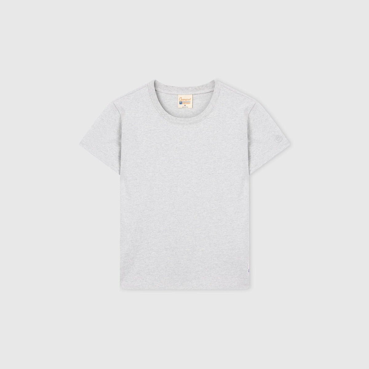 A Champion Women’s Knitted Crewneck T-Shirt in light gray is laid flat on a white background, displaying the front side and its classic crew neckline.