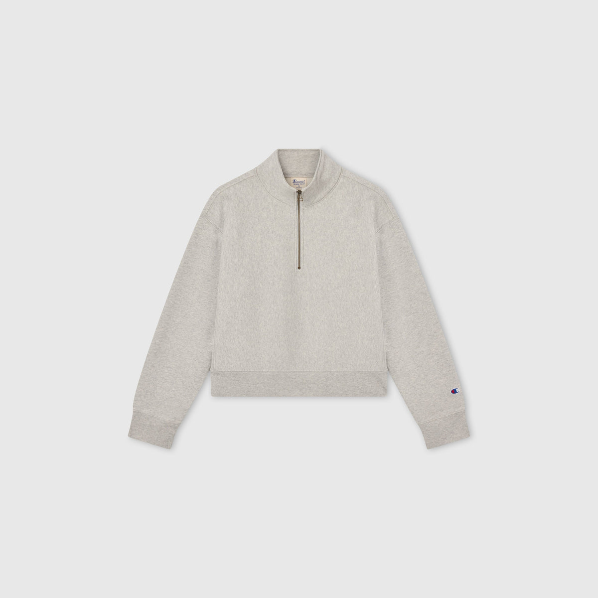Light gray Women’s Knitted Half Zip Sweatshirt by Champion, featuring long sleeves, a cropped half-zip collar, and ribbed cuffs and hem, displayed on a plain white background—a modern essential in women’s sportswear.