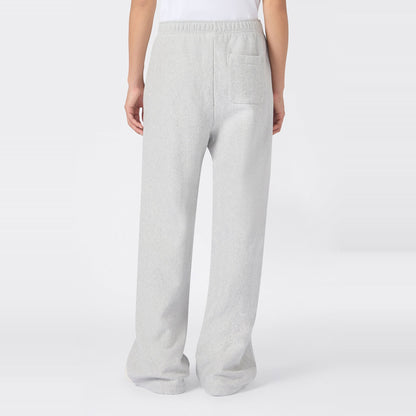 A person wearing Champion Women’s Knitted Flare Pants in light gray, featuring a heavyweight fleece construction, elastic waistband, and a single back pocket—an effortless update on classic women’s flared sportswear, shown from the back against a plain white background.