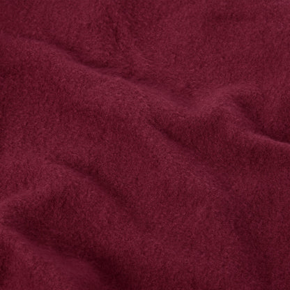 Close-up of deep red Champion Women’s Knitted Flare Pants fabric, featuring a soft, brushed texture and gentle folds.