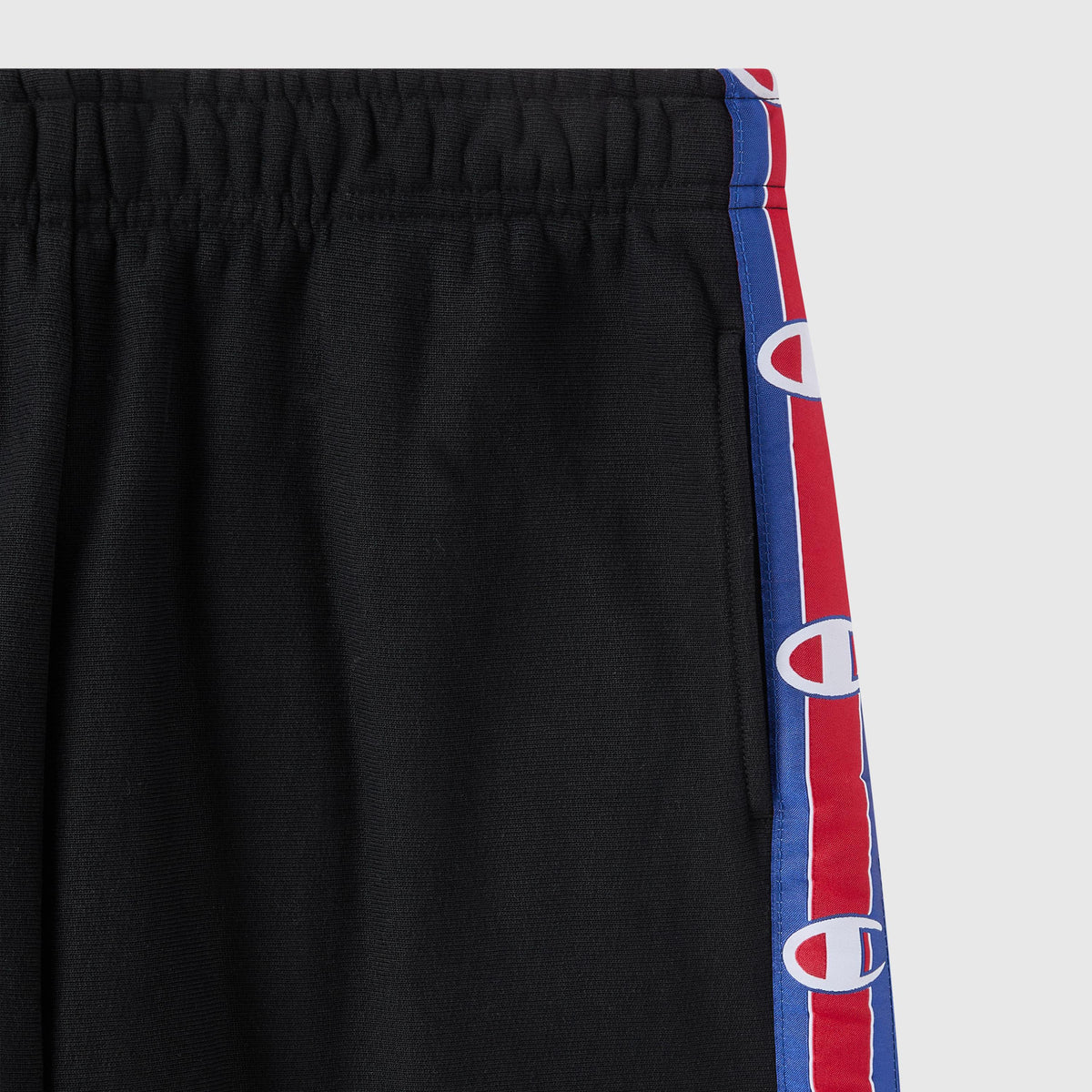 Black Women’s Knitted Wide Leg Pants by Champion, featuring an elastic waistband and red and blue side stripes adorned with repeating white C logos. The upper half of these Champion pants is visible, showcasing their iconic sporty style.