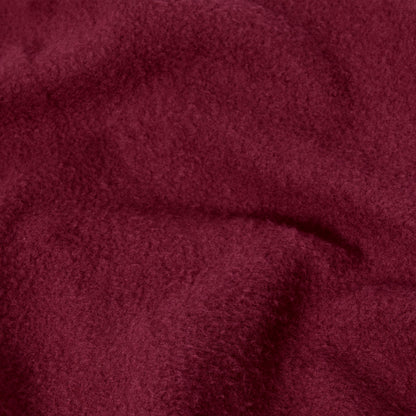 A close-up of the Champion Women’s Knitted Hooded Full Zip Sweatshirt reveals its soft, burgundy-colored knit fabric with a slightly fuzzy texture and gentle folds, evoking the plush comfort of a cozy fleece hoodie.