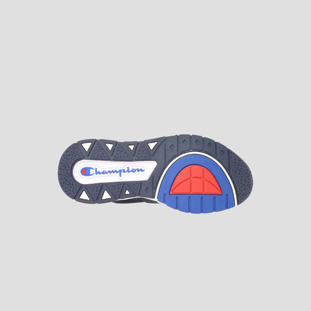 The image shows the sole of the Champion Kids' Rally Pro sneaker, featuring black, white, blue, and red accents. The Champion logo stands out in blue and red on a white background—perfect for stylish knit kids' sneakers.