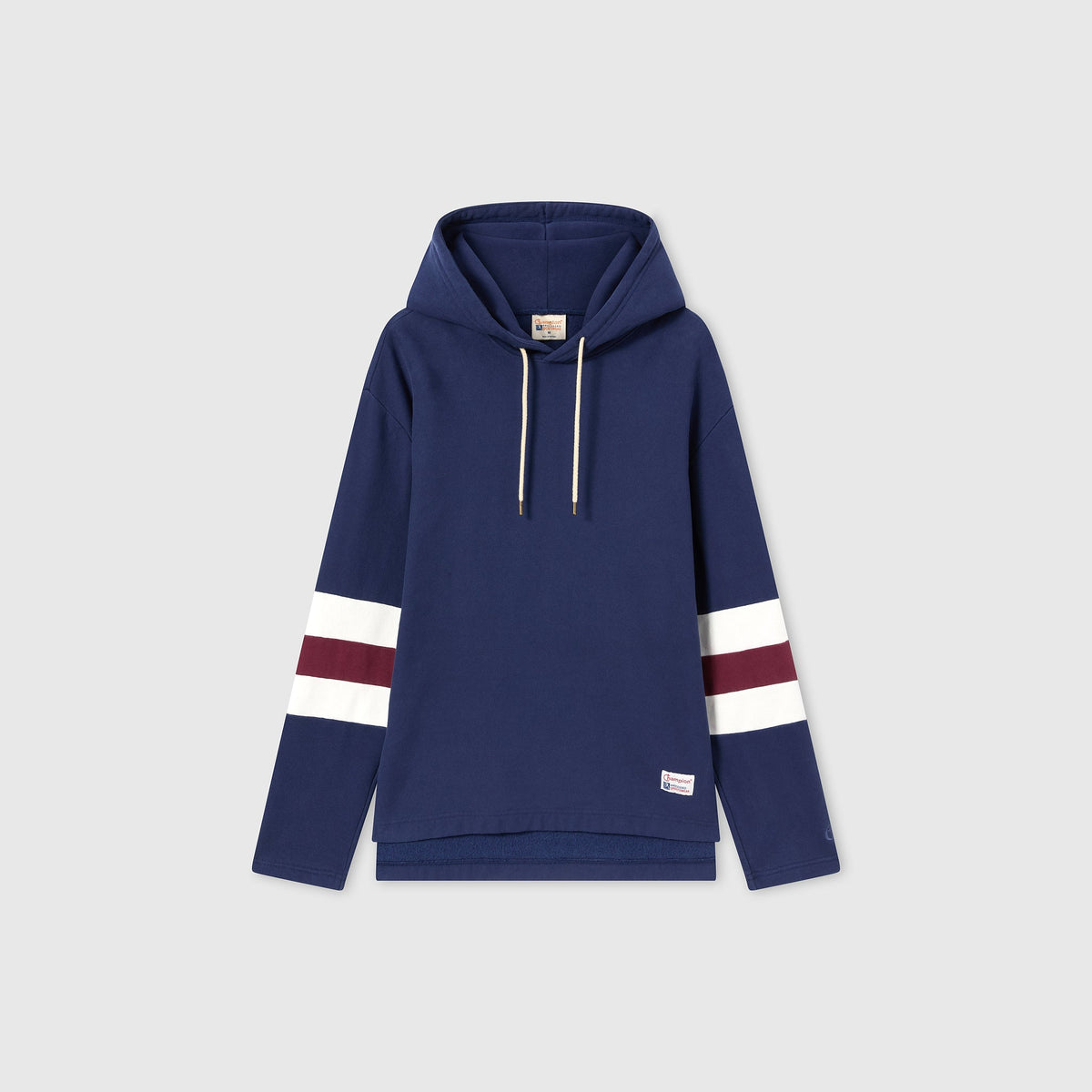 This Champion Men’s Knitted Hooded Sweatshirt features a classic navy blue color with a front pocket, white drawstrings, and horizontal white and maroon stripes on both sleeves. Made from heavyweight fleece for enhanced warmth and durability, the hoodie is showcased against a plain light gray background.