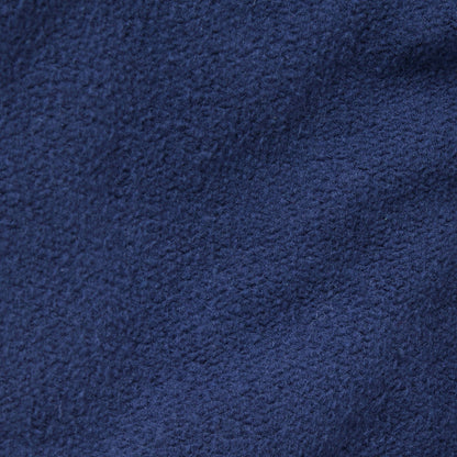 Close-up of dark blue fleece fabric from Champion’s Men’s Knitted Elastic Cuff Pants, highlighting its soft, textured surface and subtle variations in color and weave—an ideal material for comfort and style.