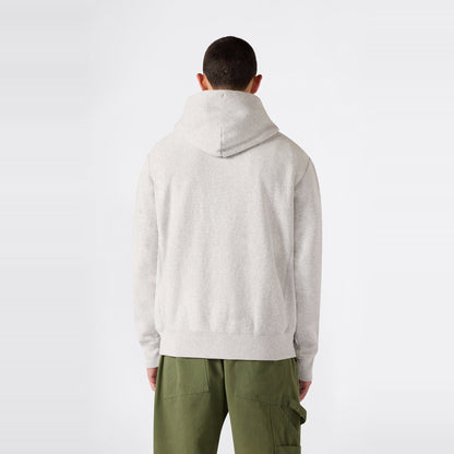 A person facing away, dressed in the Champion Men’s Knitted Hooded Sweatshirt in light gray and olive green cargo pants, stands against a plain white background.