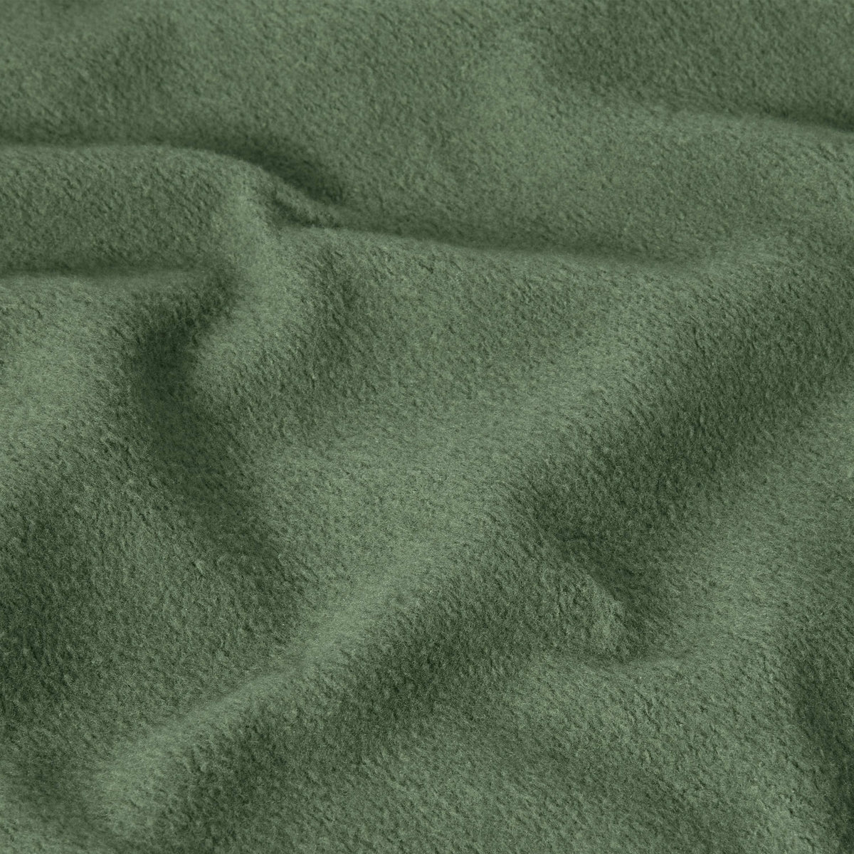 Close-up of green, soft, textured fabric with visible folds and gentle wrinkles, creating a cozy and slightly uneven surface—characteristic of the heavyweight fleece used in the Champion Men’s Relaxed Fit Hooded Sweatshirt.