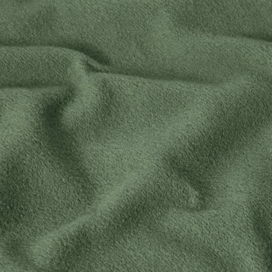 Close-up of green, soft, textured fabric with visible folds and gentle wrinkles, creating a cozy and slightly uneven surface—characteristic of the heavyweight fleece used in the Champion Men’s Relaxed Fit Hooded Sweatshirt.