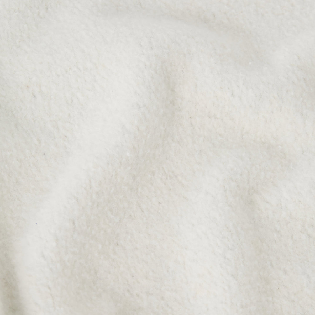 Close-up of soft, off-white heavyweight fleece with a slightly wavy texture and subtle shadows, highlighting the plush and cozy appearance typical of the Champion Men’s Relaxed Fit Crewneck Sweatshirt.