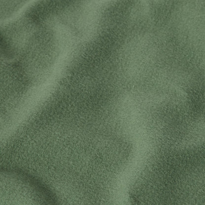 A close-up of heavyweight fleece fabric from the Champion Men’s Relaxed Fit Crewneck Sweatshirt, displaying a soft, textured surface with gentle folds and shadows.