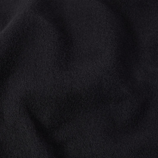 Close-up of soft, deep black fabric with a subtly fuzzy texture and gentle folds, evoking the feel of a classic Champion Men’s Knitted Crewneck Sweatshirt.
