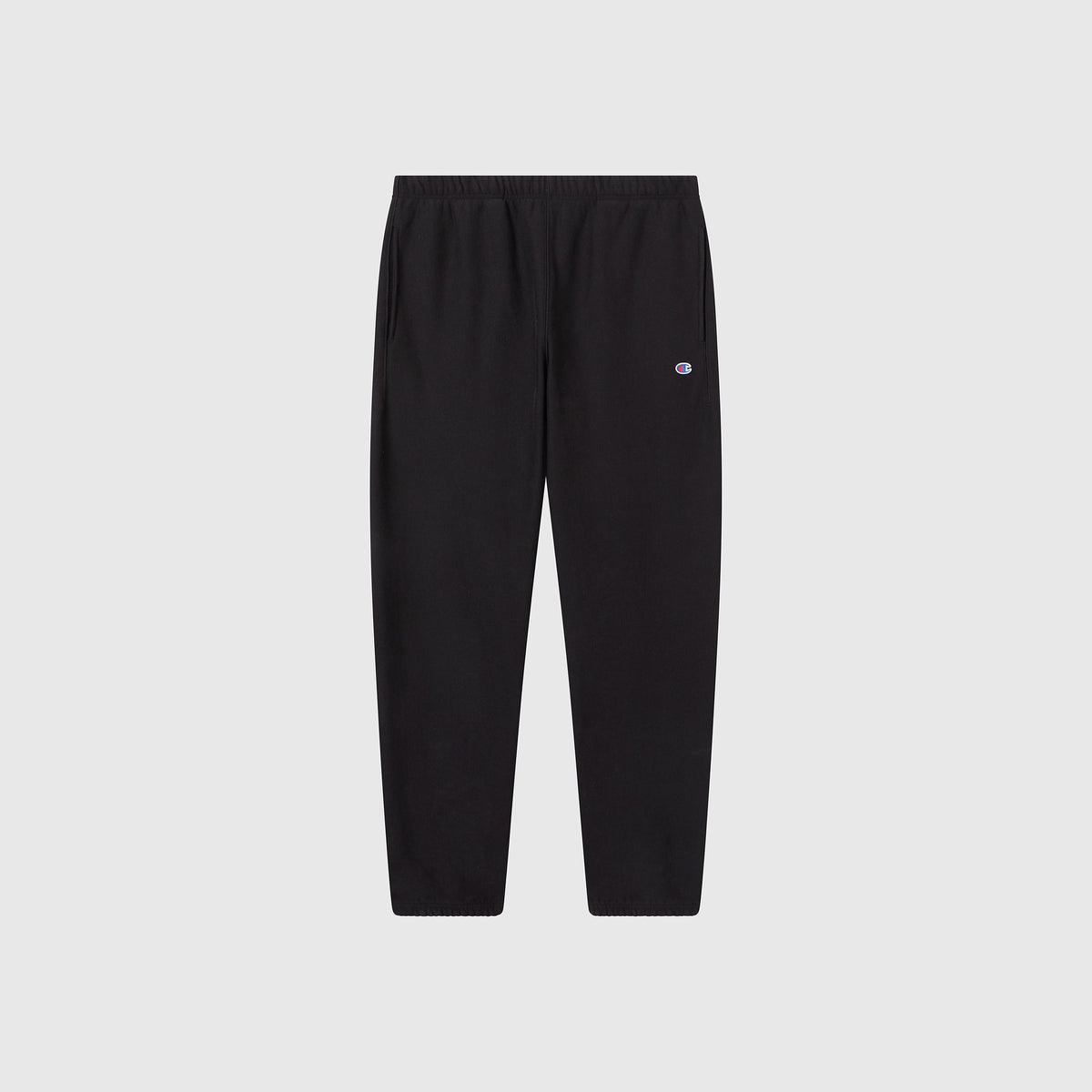 The Champion Men’s Knitted Elastic Cuff Pants are black athletic trousers featuring an elastic waistband and ankle cuffs, with a small embroidered logo on the upper left thigh, shown against a plain white background.
