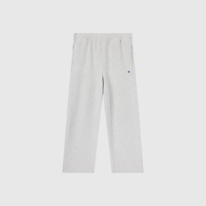 Light grey Champion Men’s Knitted Wide Leg Pants featuring an elastic waistband, wide legs, and side pockets, displayed on a plain white background. A small, colorful Champion logo is visible near the left pocket.