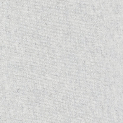 Close-up of a light gray, soft fabric texture with a slightly mottled, heathered appearance—typical of heavyweight fleece used in Champion Men’s Knitted Wide Leg Pants.
