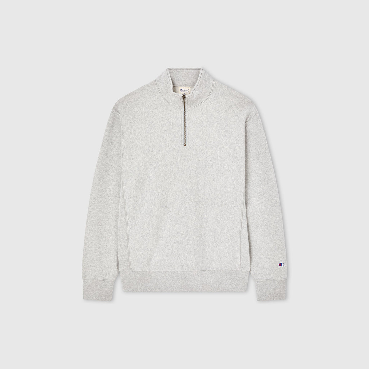Champion Men’s Knitted Half Zip Sweatshirt in light grey, featuring a high collar, long sleeves, ribbed cuffs and hem, and a small embroidered logo on the left sleeve—shown on a plain white background. This versatile fleece quarter-zip from Champion offers everyday comfort with classic style.