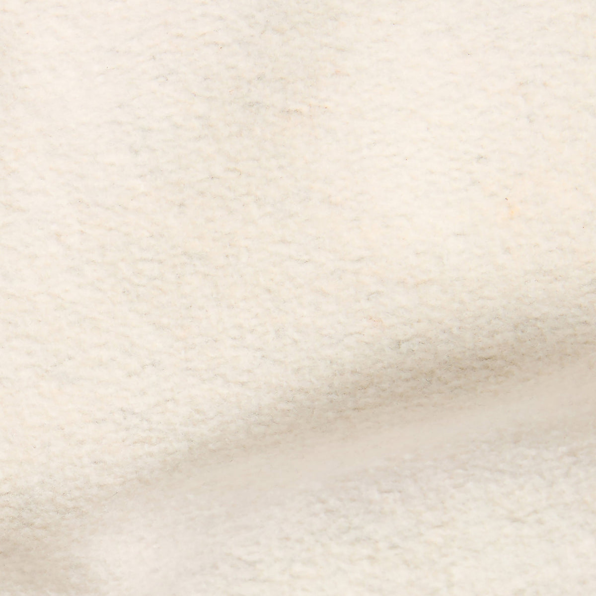 A close-up view of a soft, cream-colored, textured fabric surface with subtle folds and gentle shadows, reminiscent of the Champion Men’s Knitted Half Zip Sweatshirt.