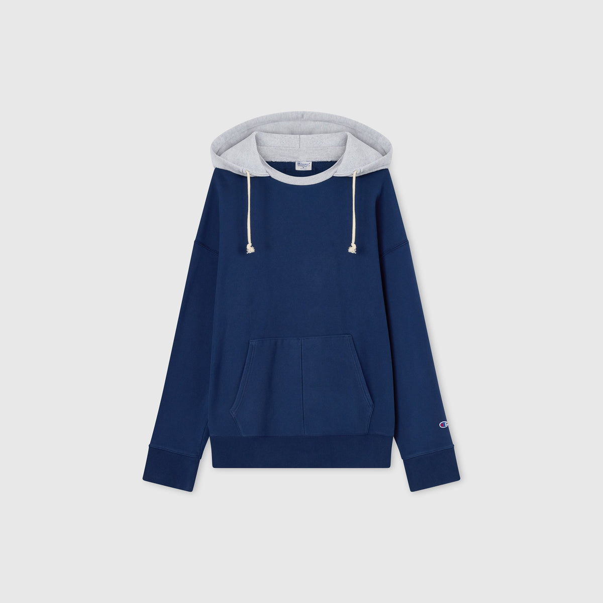 Men’s Knitted Hooded Sweatshirt (Vintage Wash) by Champion in blue, featuring a front pocket, long sleeves, and a light gray hood lining with drawstrings. Crafted from soft Reverse Weave fleece, this hoodie showcases the classic Champion logo on the left sleeve. The sweatshirt is laid flat on a plain light background, highlighting its timeless style and comfort.