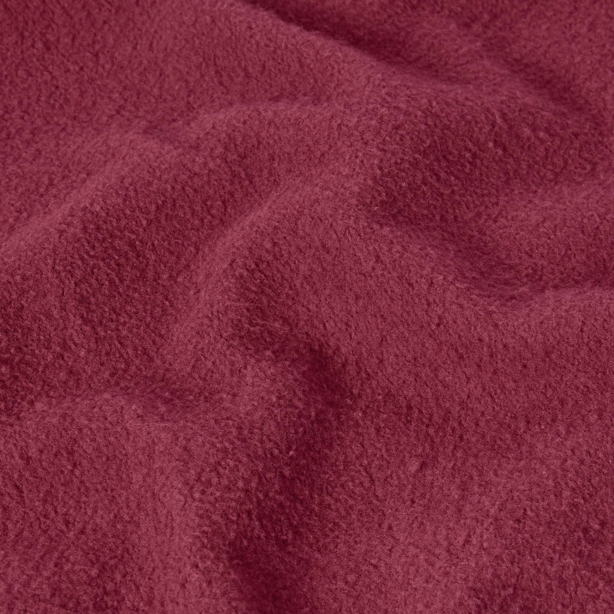 Close-up of textured maroon heavyweight fleece fabric, highlighting its soft and fuzzy surface with gentle folds and shadows—ideal for the Champion Men’s Knitted Hooded Sweatshirt.