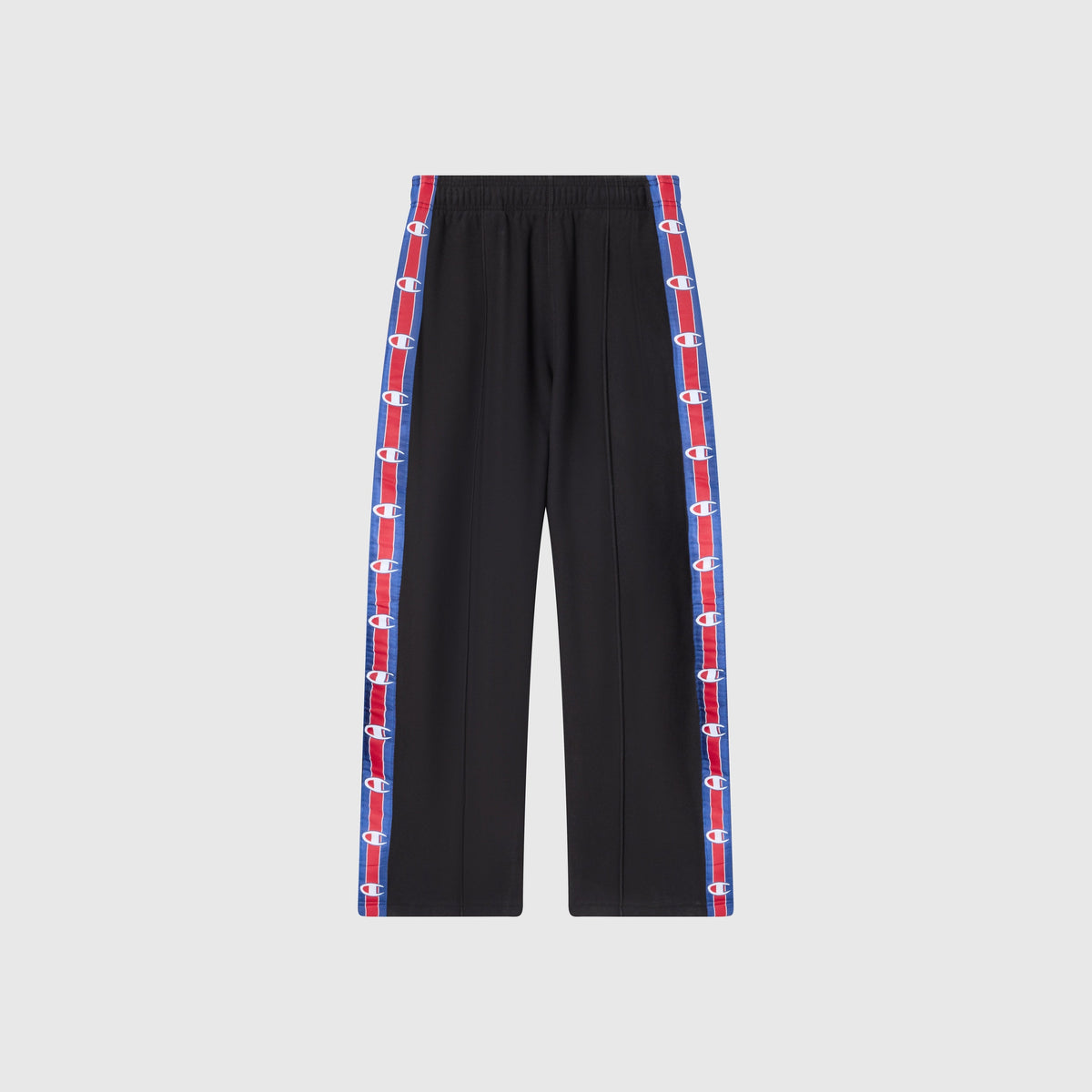 Champion Men’s Knitted Straight Hem Pants with an elastic waistband and vertical red and blue side stripes featuring repeating white logos along the outer seams, showcased against a plain light gray background—these fleece trousers blend sportswear inspiration and comfort, capturing the classic style of Champion’s heritage.