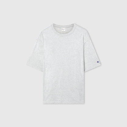 The Men’s Knitted T-Shape Tee by Champion is displayed flat on a gray background. This sportswear staple features a classic crew neckline, a subtle Champion logo on the left sleeve, and is crafted from heavyweight cotton to ensure lasting comfort and durability.