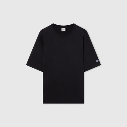 A men’s Champion Knitted T-Shape Tee in plain black, featuring short sleeves and heavyweight cotton fabric, with a small logo on the left sleeve, displayed on a white background.