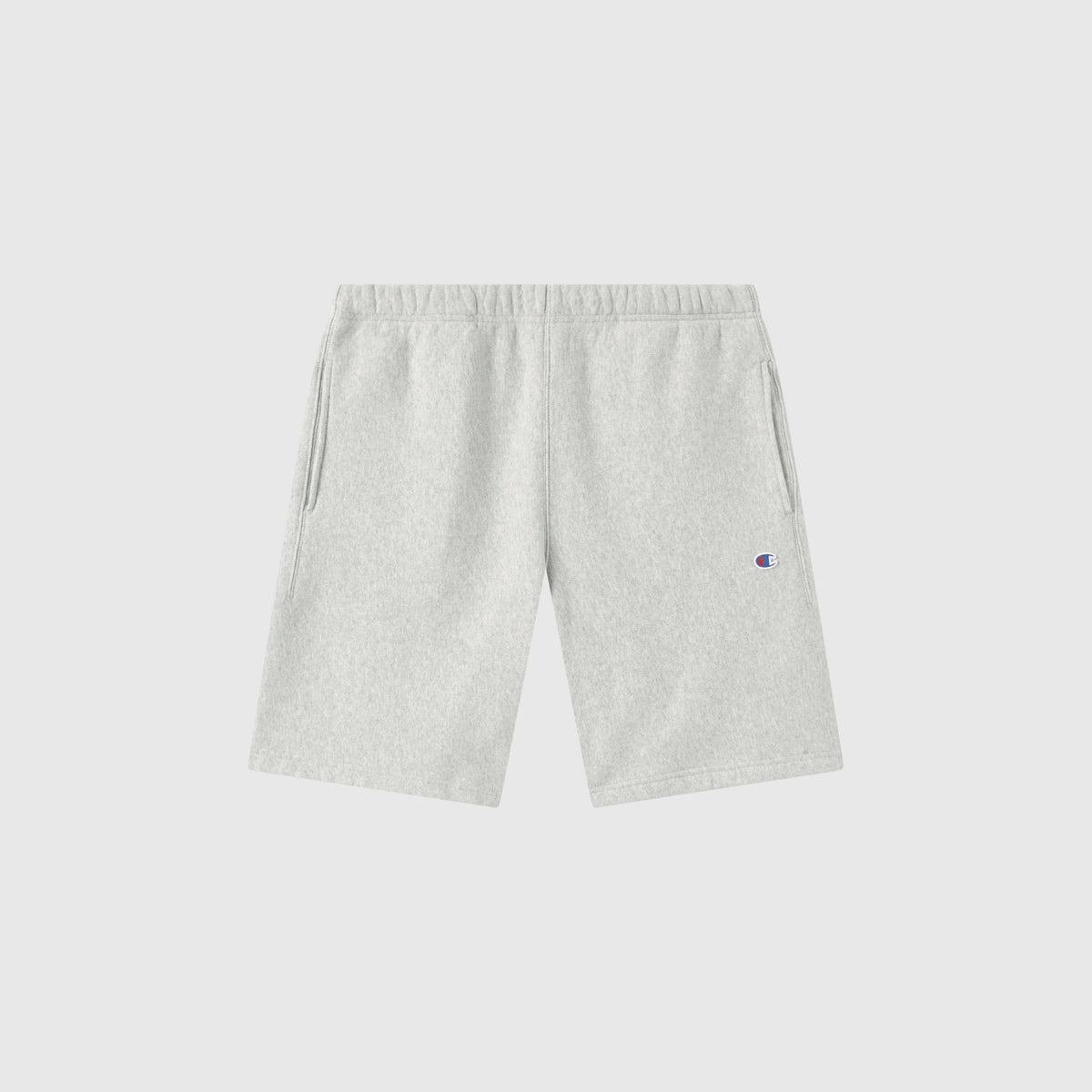 Men’s Knitted Shorts by Champion in light gray, featuring an elastic waistband, side pockets, and a small embroidered Champion logo on the left leg, crafted from heavyweight sportswear fleece and displayed against a plain white background.