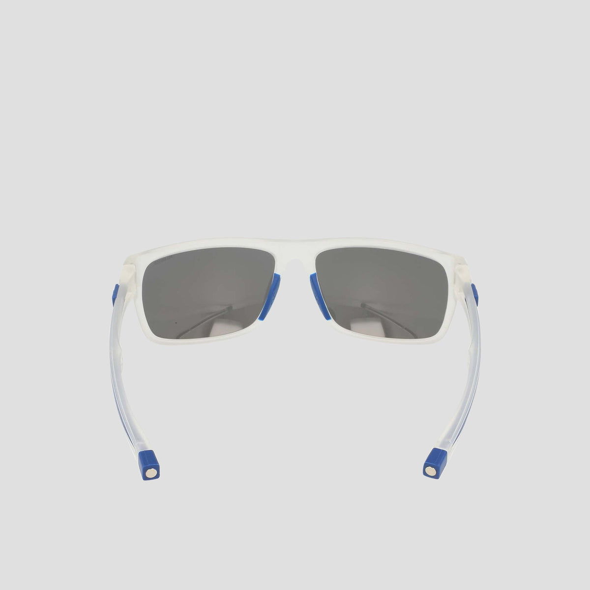 Champion Men's Polarized Wrap - Large sunglasses featuring sustainable white frames with dark polarized lenses, blue accents on the corners and nose pads, and flexible clear arms finished with blue tips, displayed on a light gray background.