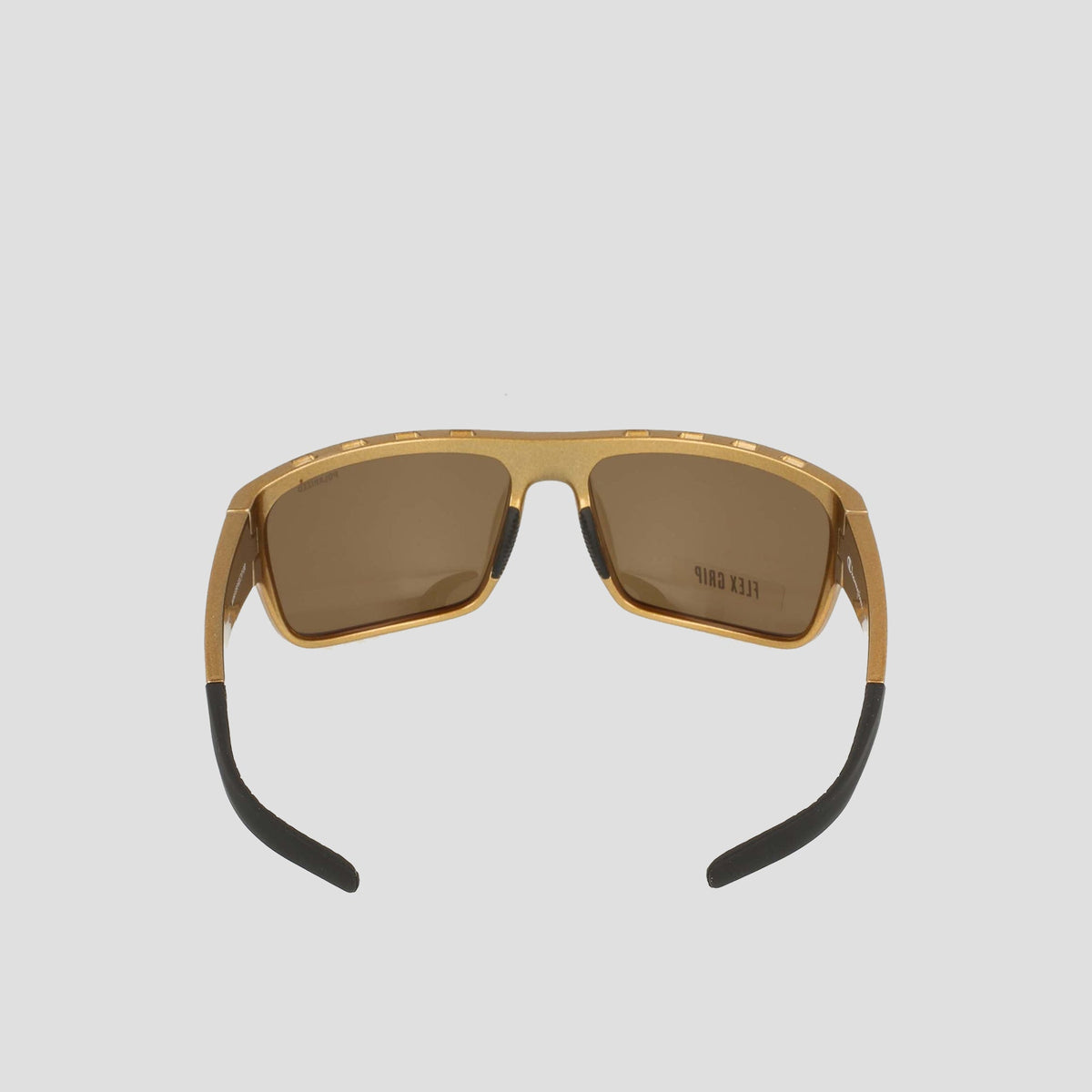 Champion Men’s Polarized Grilamid Flex Grip Tip - Large sunglasses feature a gold frame, brown polarized lenses, and black-tipped arms. Shown from the front against a plain light gray background, these shades are designed for lightweight comfort—combining clarity and style wherever you go.